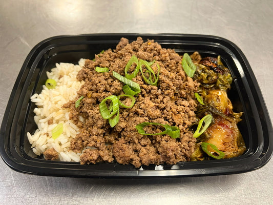 Korean ground beef over steamed rice with bang bang brussels