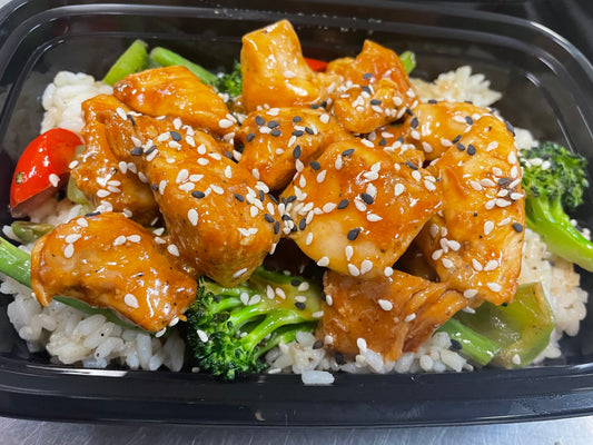 Sesame chicken over white rice with stir fry vegetables